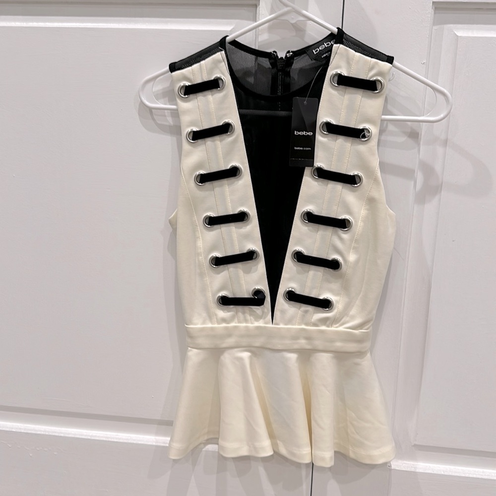 New with tags on sexy with mesh back top. It also comes in XS size.